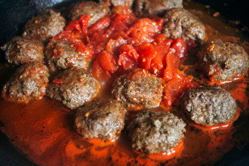 Obraz na płótnie Canvas Beef and pesto meatballs in tomato sauce. 