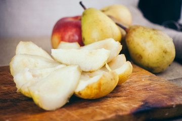Sliced pear on a wooden board, closeup. 