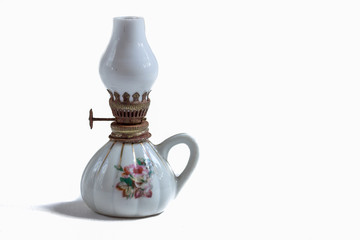 close up of a white mini glass oil lanp isolated on white