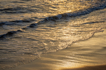 Sea waves on a sunset in the beach