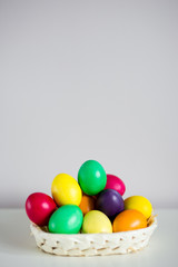 Fototapeta na wymiar Easter background - colorful eggs on the table with copy space