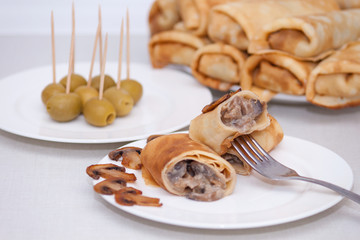 Maslenitsa. Pancake rolls or French stuffed crepes with mushrooms