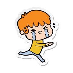 sticker of a cartoon boy crying