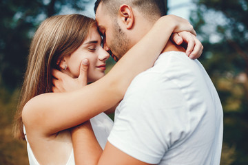 Beautiful couple spend time in a summer park