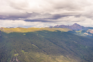 Naklejka premium Alpe di Siusi, Seiser Alm with Sassolungo Langkofel Dolomite, a view of a large mountain in the background