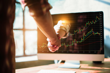 Hand reaching out from computer screen to shake hand - Image