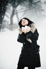 Asiatic woman enjoying a winter storm outdoor