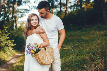 Beautiful couple spend time in a summer park