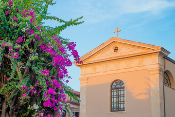 Catholic church near blooming bougainvillea. The old town of Rethymnon is one of the best-preserved towns of the Renaissance.