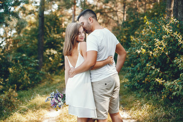 Beautiful couple spend time in a summer park
