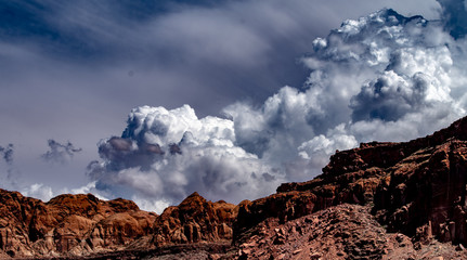 Storm clouds over the red rock of Lake Powell, Utah with white and grey clouds, blue sky