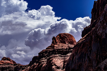 Storm clouds over the red rock of Lake Powell, Utah with white and grey clouds, blue sky