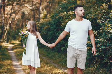 Beautiful couple spend time in a summer park