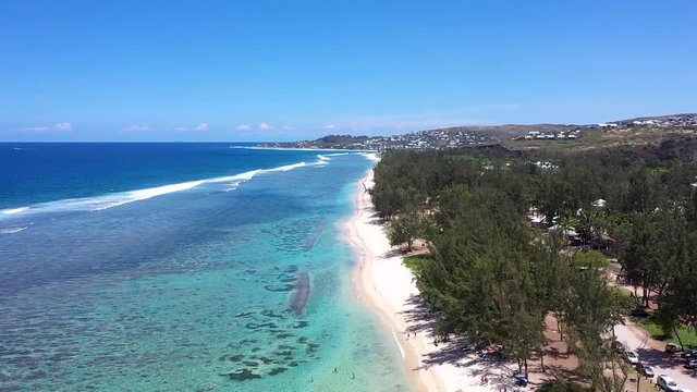 Aerial view over the coast of Reunion Island with waves dying on the coralreefs.