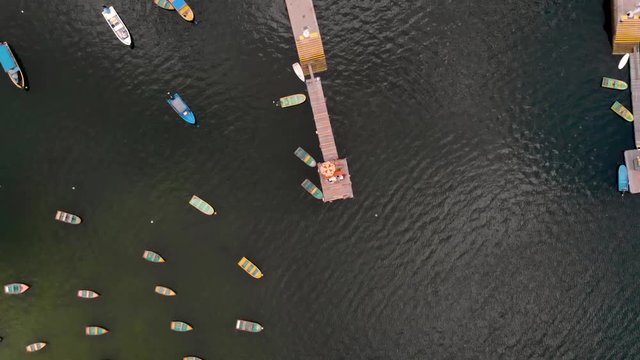 Gentle rise above a jetty with lots of little boats moored up at Tai Mei Tuk pier, Secret place outside Hong Kong, China, Aerial shot