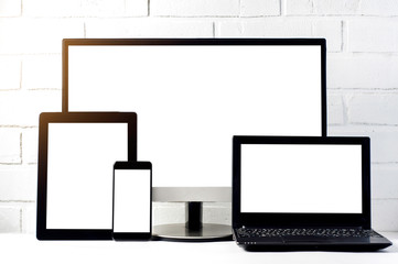 Monitors and tablets on a light background. Template for text or design of the website