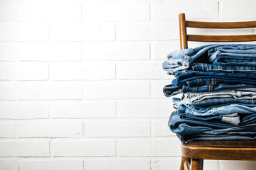 Fototapeta na wymiar A stack of old jeans on a light background