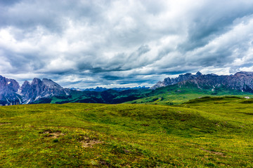 Alpe di Siusi, Seiser Alm with Sassolungo Langkofel Dolomite, a large green field with a mountain in the background