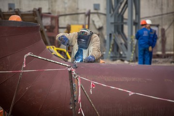 factory workers at Koksokhim, welders are engaged in the construction and installation of metal structures on high ground and in special working conditions