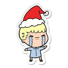 sticker cartoon of a man crying wearing santa hat
