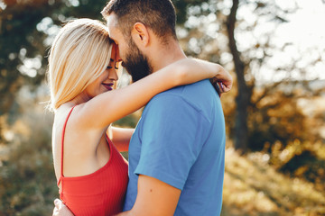 Beautiful couple spend time in a summer park