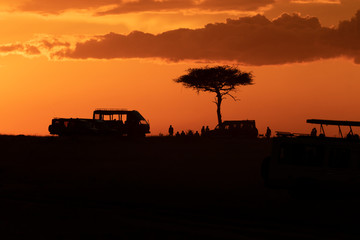 Fototapeta premium A sundowner party in the evening inside Masai Mara National Reserve to end a beautiful day of safari