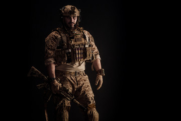 Fototapeta na wymiar Special forces United States soldier or private military contractor holding rifle. Image on a black background. war, army and people concept