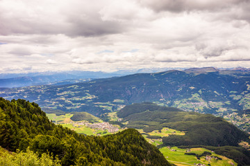 Naklejka premium Alpe di Siusi, Seiser Alm with Sassolungo Langkofel Dolomite, a view of a large mountain in the background