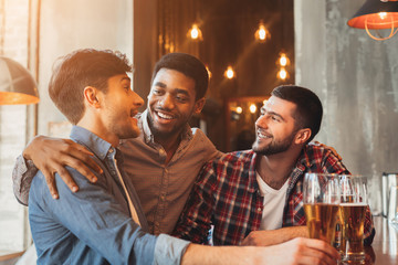 Best friends drinking beer, meeting in pub