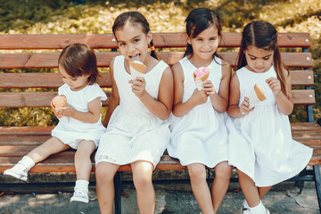 Cute little sisters in a summer park