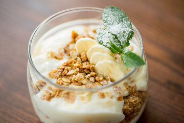 dessert with fresh cream, nuts and banana