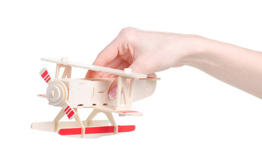wooden constructor model airplane in hand on white background isolation