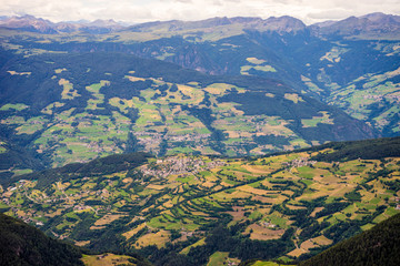 Alpe di Siusi, Seiser Alm with Sassolungo Langkofel Dolomite, a close up of a lush green field in a valley canyon