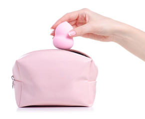 Make up sponge puff in hand put in cosmetic bag on white background isolation