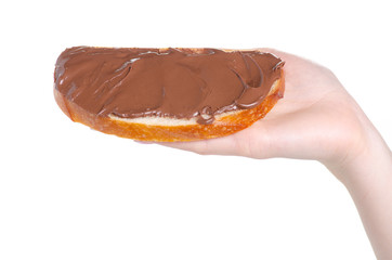 Bread with chocolate spread paste in hand on white background isolation