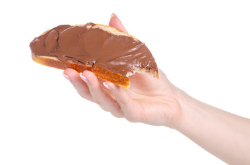 Bread with chocolate spread paste in hand on white background isolation