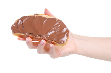 Bread with chocolate spread paste in hand on white background isolation