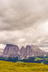 Fototapeta premium Alpe di Siusi, Seiser Alm with Sassolungo Langkofel Dolomite, a large mountain in the background