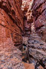 young man enjoying the view of the Handrail Pool, Weano Gorge, Karijini National Park, Western Australia