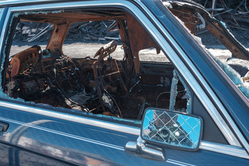 Burned out cars and a collapsed building