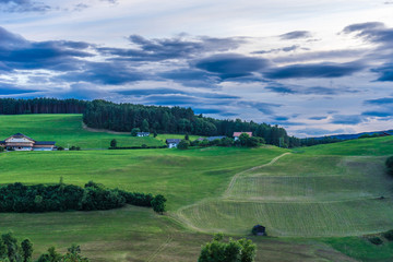 Fototapeta na wymiar Alpe di Siusi, Seiser Alm with Sassolungo Langkofel Dolomite, a large green field with trees in the background