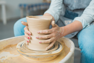 girl makes a jug of his own hands in a pottery workshop	