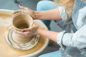 girl makes a jug of his own hands in a pottery workshop	
