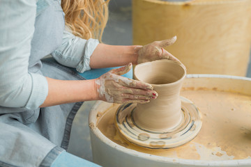 girl makes a jug of his own hands in a pottery workshop	