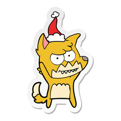 sticker cartoon of a grinning fox wearing santa hat