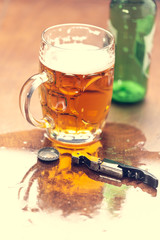 Bottle opener and beer on the bar.
