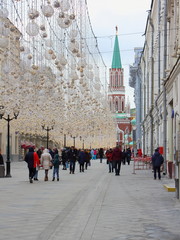 Moscow / Russia – Pedestrian street Nikolskaya with walking people in the city center with decorations for the holiday on a winter day