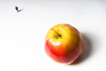 Apple and a toy figure of a boy