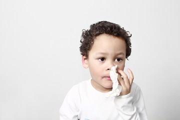 child blowing nose after catching a cold