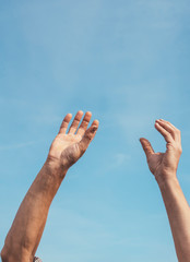 Man's hands rising to the sky